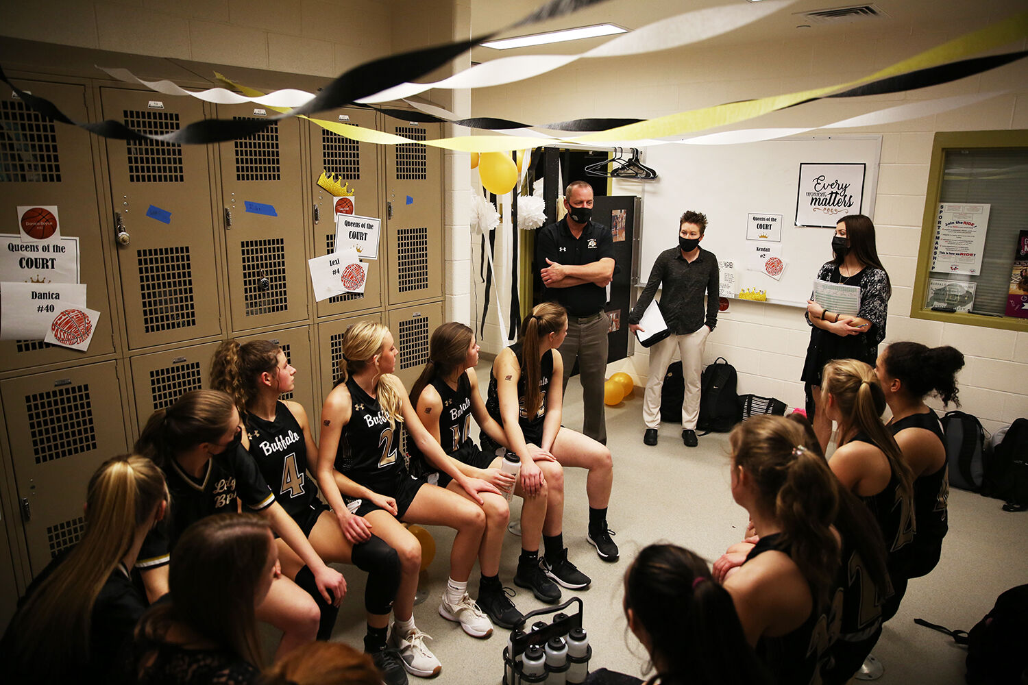 The team listens to Keith Leppert during halftime